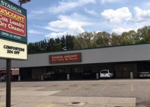 stadium discount coin laundry dry cleaners sign and building and parking