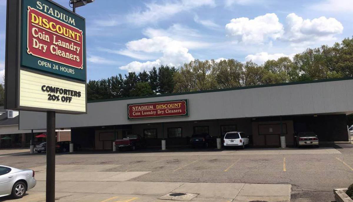 stadium discount coin laundry dry cleaners sign and building and parking